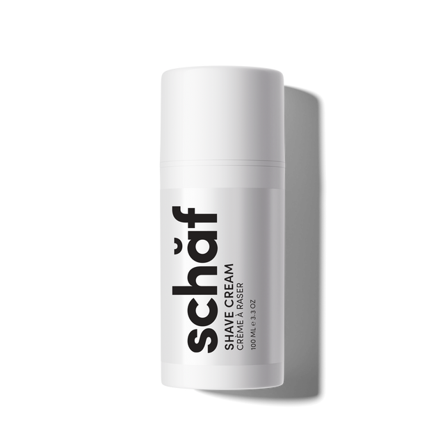 White cylindrical container of Schaf shave cream on a white background